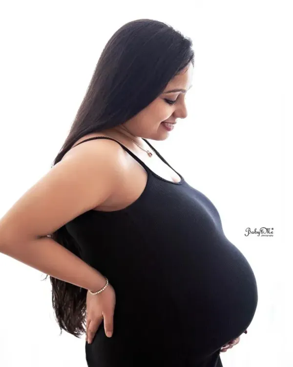 A simple, classic silhouette shot. This side profile against a clean white background is a beautiful way to capture the perfect shape of a baby bump.