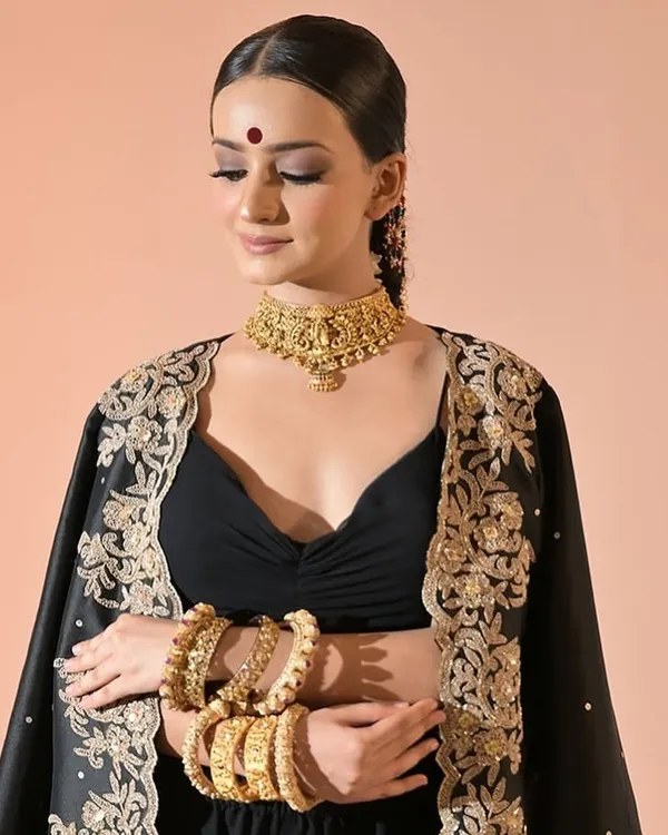 Our temple jewellery choker paired with heavy bangles creates a stunning festive look. This set gives the feel of real gold and is perfect for traditional outfits.
