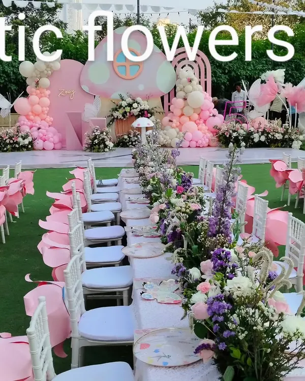 A magical, fairy-themed birthday party. We created a complete outdoor setup with a pink mushroom-themed stage, balloon arrangements, and long dining tables adorned with beautiful floral runners.