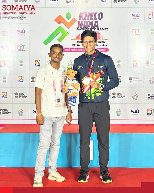 Jai Bhoir stands on the podium with his bronze medal won in the 100m sprint at the Khelo India University Games, a proud national-level achievement.