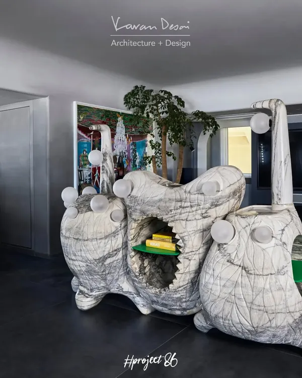 A closer look at the Monster Console, a piece of functional sculpture carved from a single marble block. The design incorporates open shelving and integrated globe lights, making it as practical as it is visually striking.