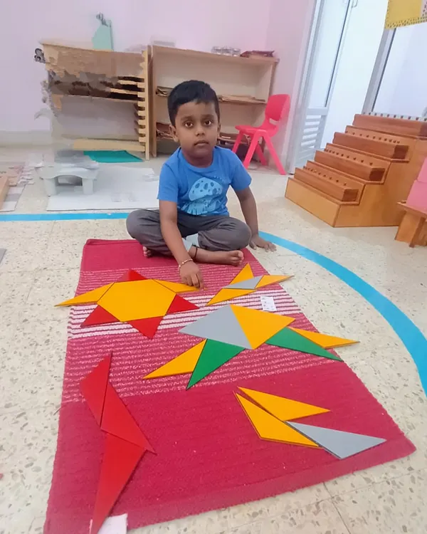 These are the Constructive Triangles. By combining different triangles, this child is discovering how they can form other shapes like squares and rectangles. It's a hands-on, problem-solving approach to learning geometry.