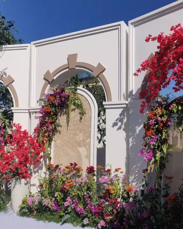 The full ceremony setup on the couple's home terrace. We used architectural arches and an explosion of colorful flowers, including their favorite bougainvillea, to create a stunning and personal mandap.