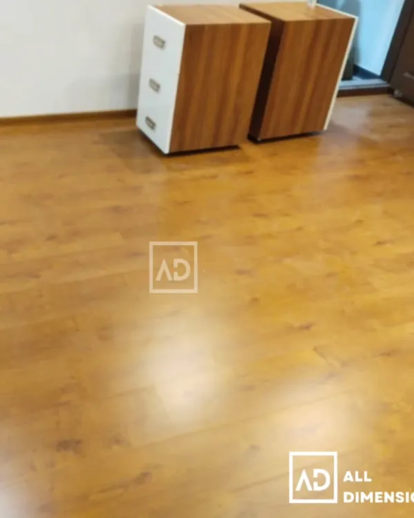 Installation of a wood-finish PVC flooring in a room. This gives the classic look of wood but with the added benefits of being waterproof and highly resistant to scratches and dents.