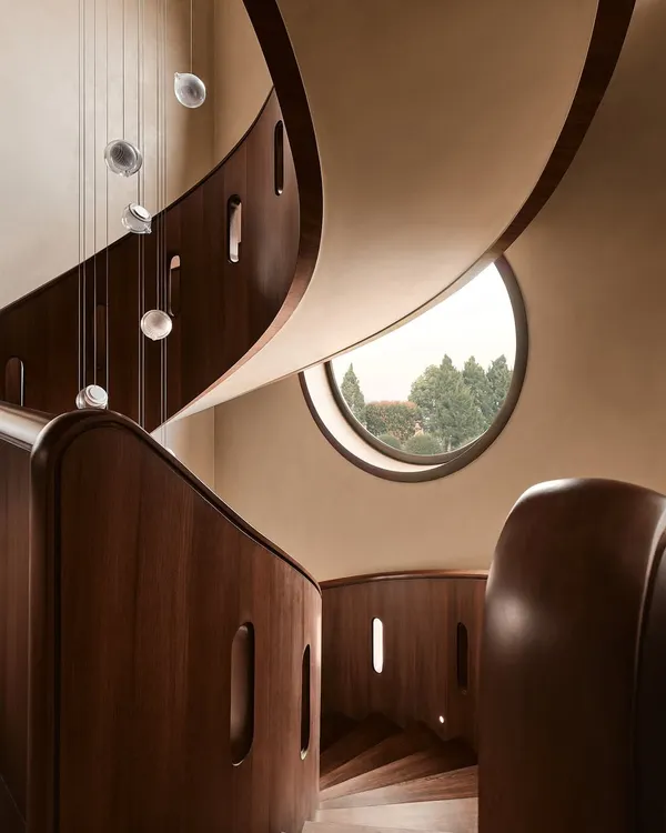 This sculptural, free-flowing wooden staircase is the heart of our Embassy 821 project in Bangalore. We designed it not just for passage, but as a piece of functional art, with cascading glass pendants that create a dynamic play of light and shadow, embodying our belief in modern organic luxury.