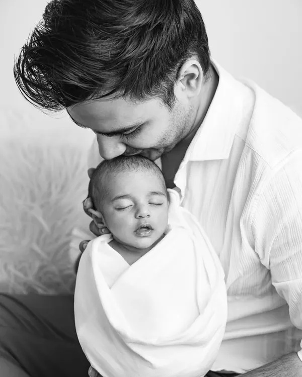 This is the kind of moment I live to capture. The pure, quiet love of a father holding his newborn for the first time, preserved forever in a timeless black and white portrait.