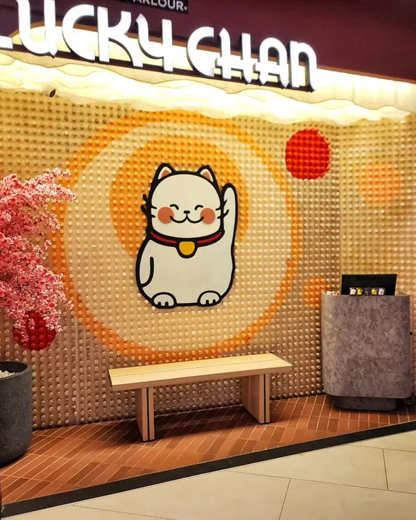 We designed and built this entire entrance feature for Lucky Chan, a sushi parlor in Bengaluru. The backdrop for their iconic cat mascot is a complex mosaic we created using 1,408 individually placed and painted wooden pegs.