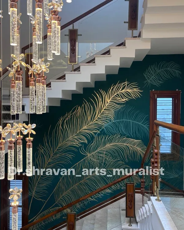 This gold foil feather design on a deep teal wall is one of my most popular styles. The way it sweeps up the staircase next to the grand chandelier creates a truly breathtaking and viral-worthy look.