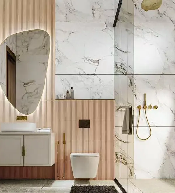 A luxurious bathroom featuring a floating vanity with a vessel sink, a backlit mirror with an organic shape, and a mix of marble and pink fluted tiles. The design is both elegant and functional.