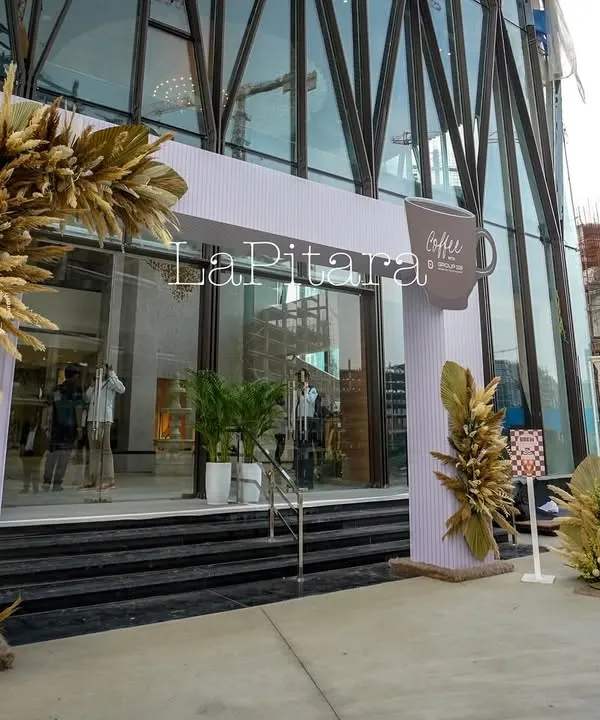 The grand entrance to our "Coffee Fest" for Group 108. We designed this modern arch with rustic pampas grass arrangements to establish the event's aesthetic and welcome guests into the themed experience.