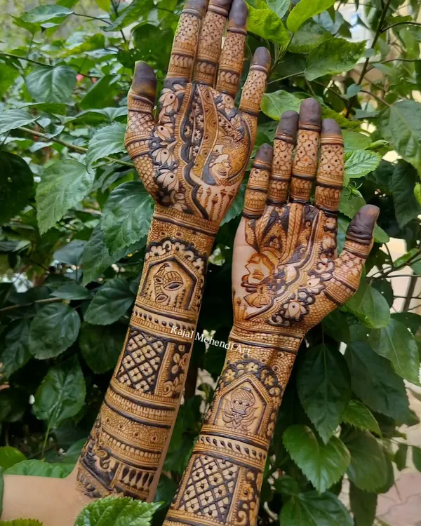 A classic and intricate full-hand bridal design, photographed against a natural green background to make the henna details pop. This pattern features traditional motifs perfect for any bride.