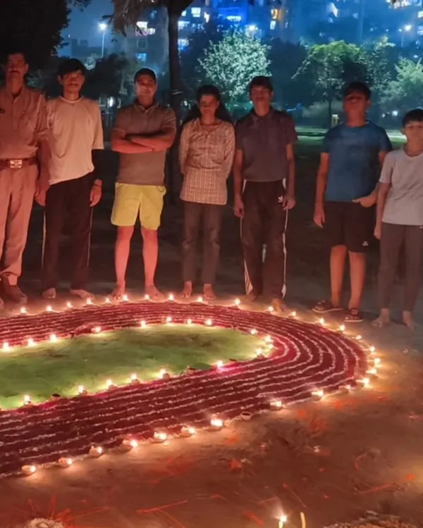 Our whole group celebrating Diwali. We created this special rangoli of a running track and a long jumper to show our shared passion for athletics.