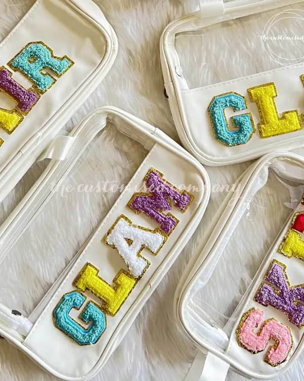There’s no such thing as too many organizers, especially when they’re this pretty. These clear pouches are personalized with sparkling, colorful chenille letter patches spelling out "GLAM," "SKIN," and "HAIR."