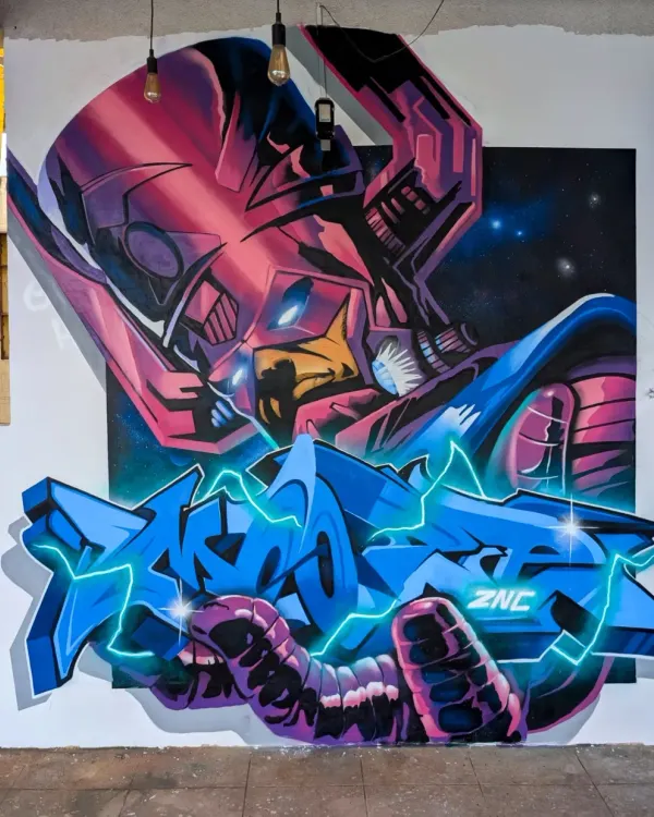 My finished Galactus mural, a piece that combines my love for comic book villains and graffiti art. This was painted on a huge canvas, using spray paint to get those cosmic blends and sharp letter effects.