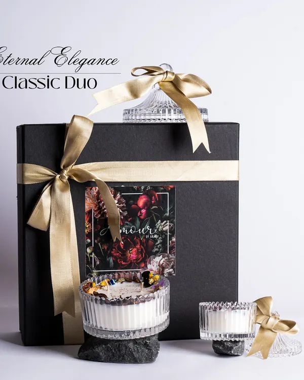 Our Eternal Elegance Classic Duo gift set. This showcases our premium black gift box with gold ribbon, containing two beautiful crystal jar candles, making for a truly luxurious gift.