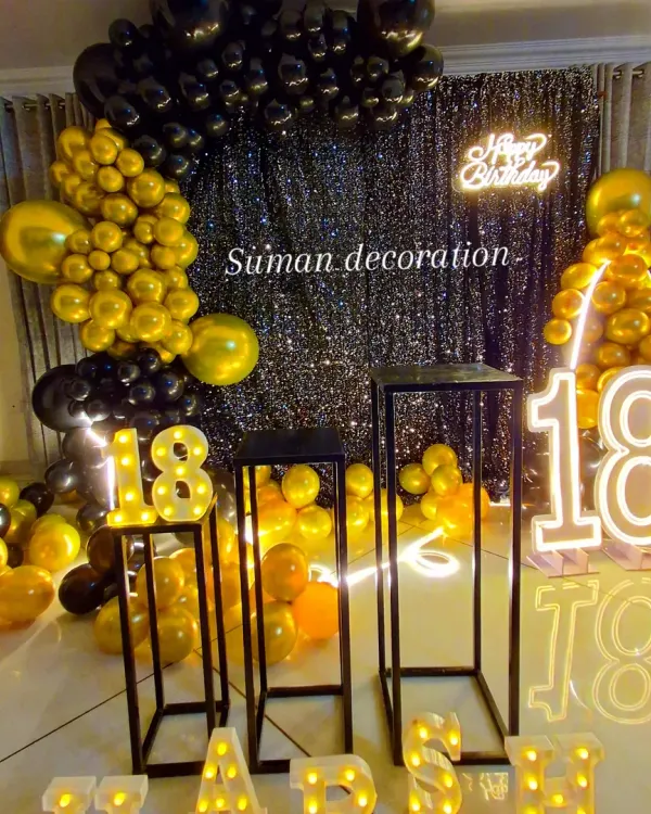 A closer look at the sophisticated black and gold 18th birthday setup. You can see the light-up marquee numbers and letters, which I can customize for any name and age.