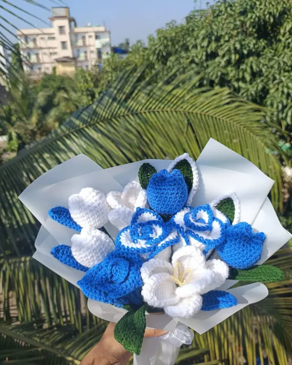 A custom blue and white bouquet, beautifully wrapped and ready for a special occasion.