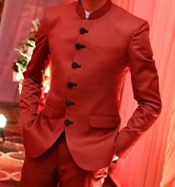 This is the kind of sharp, confident look I deliver. A client looking dapper in a custom-tailored vibrant red Jodhpuri suit, perfectly fitted for a wedding celebration.