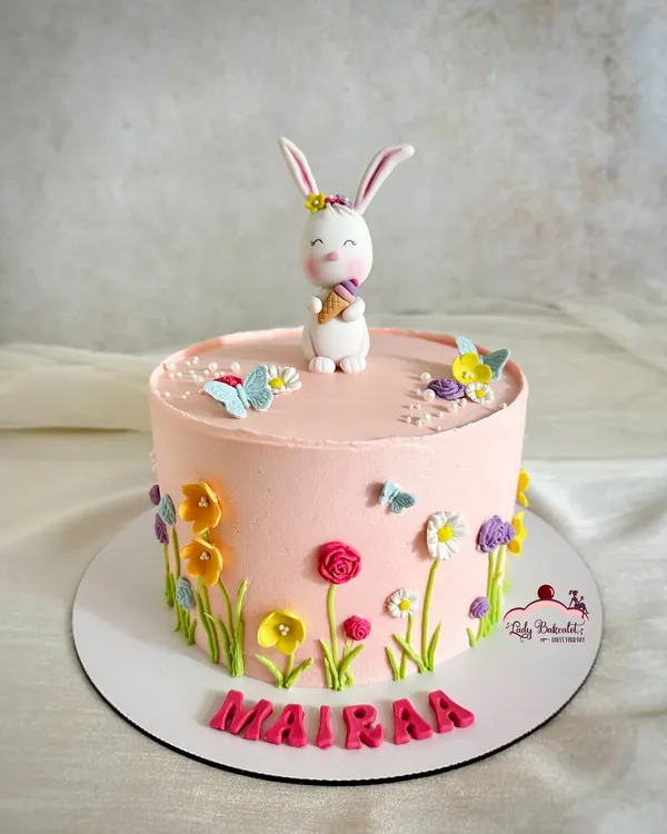 I designed this adorable Easter cake for a little one named Mairaa. The buttercream cake is decorated with hand-piped wildflowers, and the cute bunny topper holding an ice cream cone adds a playful touch.