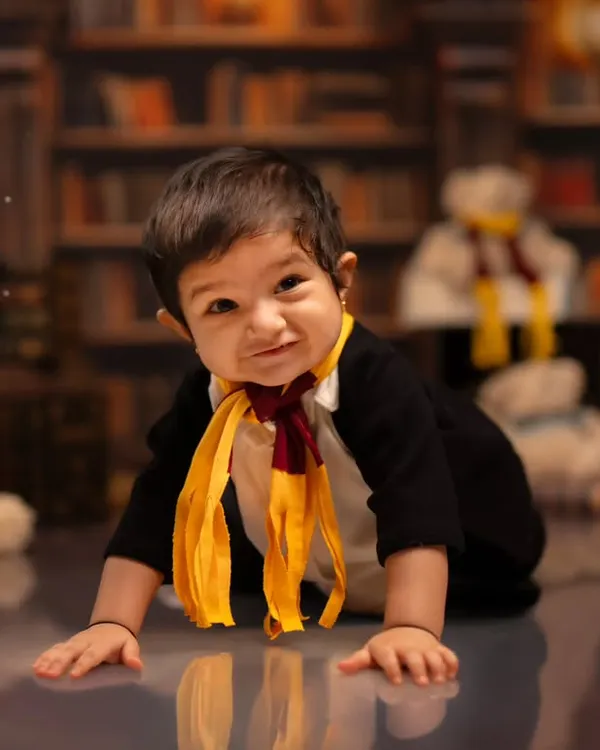 A playful crawl through our Hogwarts-inspired library set. This image from a Harry Potter themed toddler shoot captures the magic and movement of your little one exploring the set.