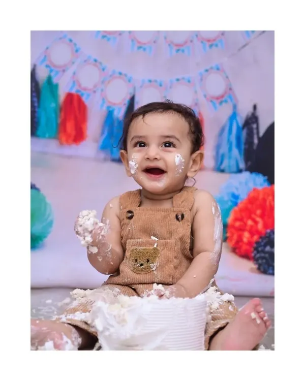 This is the moment it's all about. The pure, unfiltered joy of a first birthday cake smash, with frosting on the hands and the biggest smile. I capture these wonderfully messy memories for you to cherish.