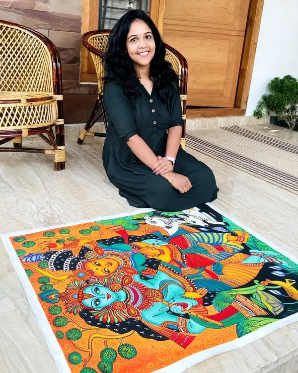 Here I am with a completed Radha Krishna mural-style painting. I love working on large canvases like this, filling them with the bright, bold colors and intricate details that are characteristic of Kerala's traditional art.