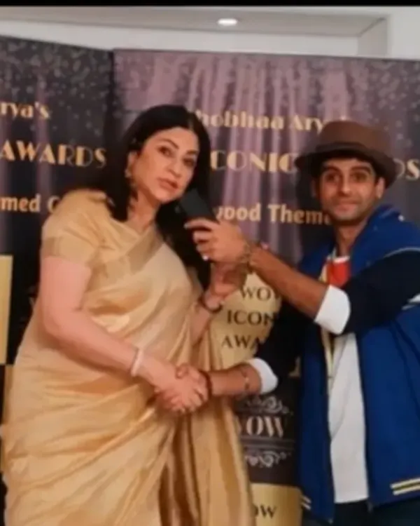 Shaking hands with actress Kunicka Sadanand during a red carpet interview for the WOW Iconic Awards. I maintain a professional and respectful demeanor while hosting.