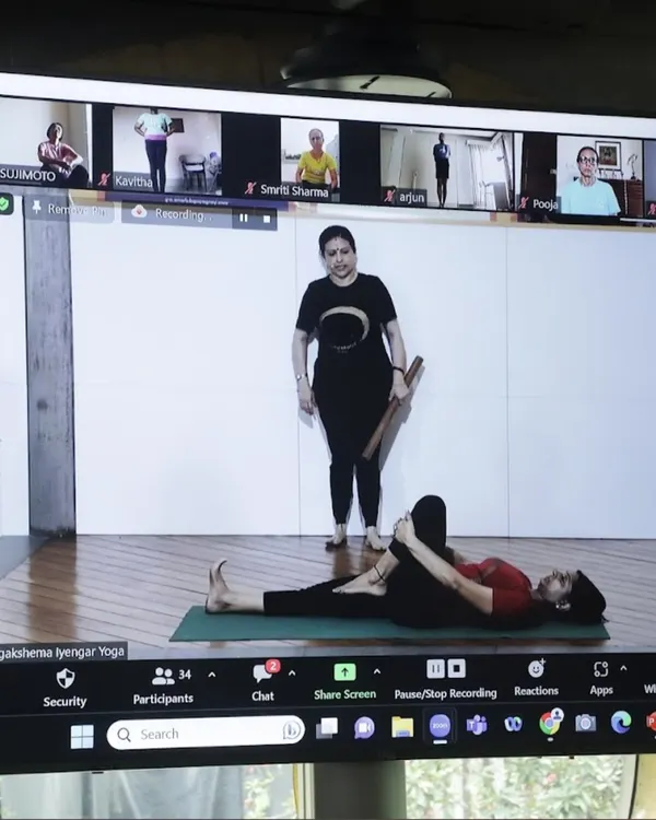 A look into my hybrid class, where I guide students both in the studio and online. Here, I am demonstrating a pose while students on Zoom follow along, ensuring everyone receives personal attention.