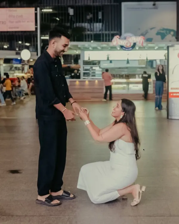 The moment Hanisha went down on one knee at the airport. Capturing a surprise proposal in a busy public space requires careful planning and discretion, allowing the moment to unfold naturally without interruption.