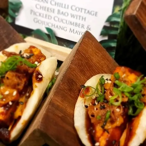 Our signature Korean Chilli Cottage Cheese Bao. The soft bao bun is filled with spicy cottage cheese, pickled cucumber, and gochujang mayo, a flavour explosion in every bite.