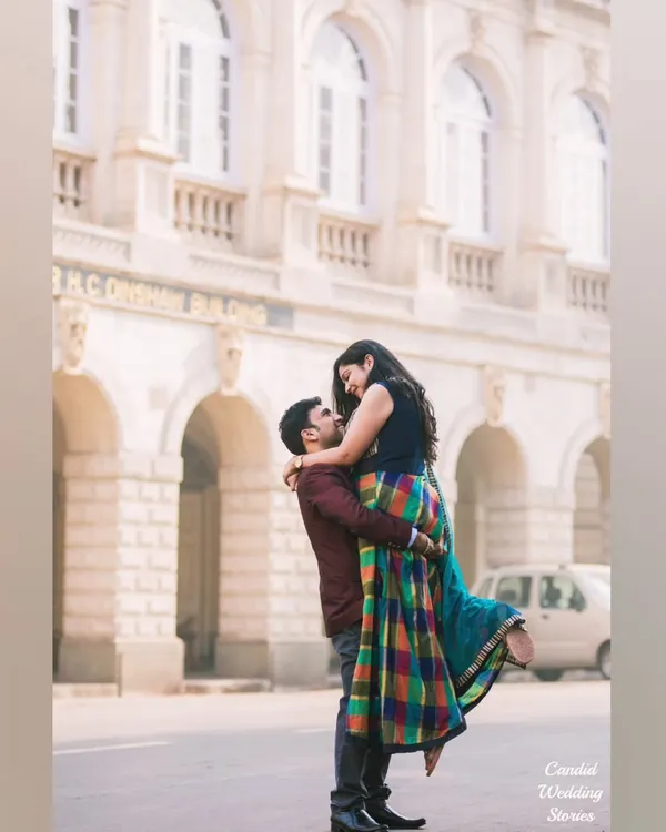 A joyful lift against the classic architecture of Mumbai. We aim to capture dynamic, spontaneous emotions that create powerful, lasting memories for our couples.