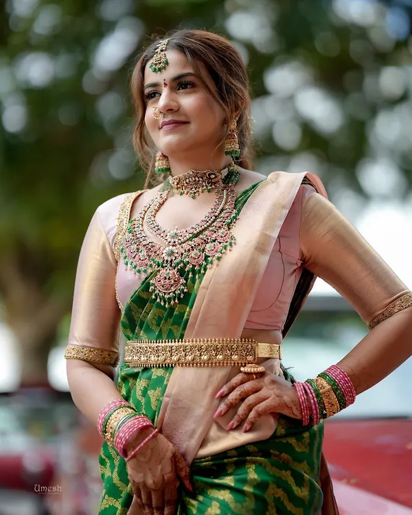 One of my cutest clients looking absolutely lovely in a green and pink saree, paired with a grand layered kempu stone necklace set.
