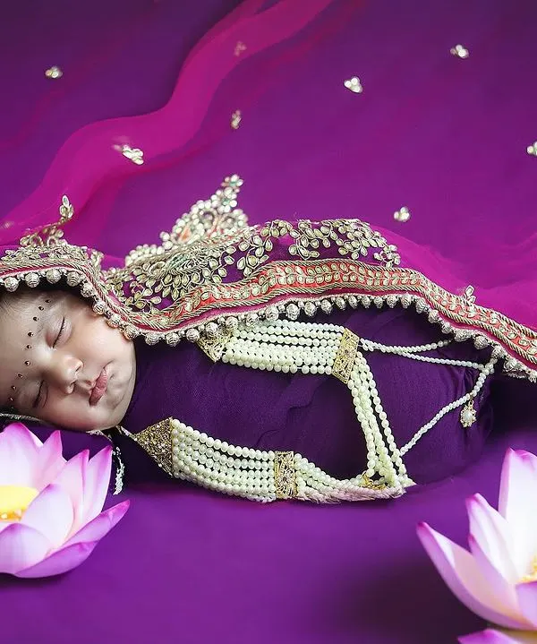 A divine newborn portrait for Navratri. I styled this sleeping baby as a little goddess, using rich colours, traditional jewelry, and symbolic lotus flowers to create a truly special image.