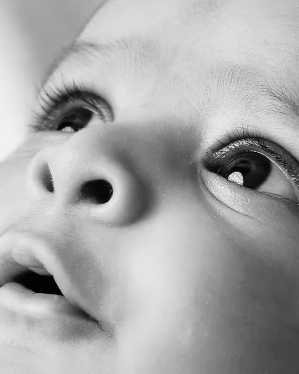 A stunning black and white close-up capturing the wonder in a baby's eyes. These macro shots focus on the tiny, perfect details you'll want to remember forever.