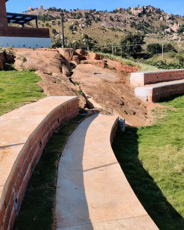 We transformed a natural rock formation at our Nandi Hills project into an informal amphitheater. This is a perfect example of our site specific design approach, using existing contours and features to create unique, functional outdoor spaces.