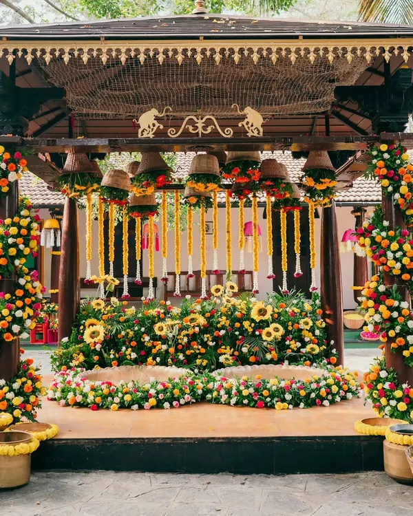 A spectacular Haldi stage overflowing with sunflowers and marigolds. We use an abundance of fresh, bright flowers to create a joyful and photogenic setting for this fun-filled ceremony.