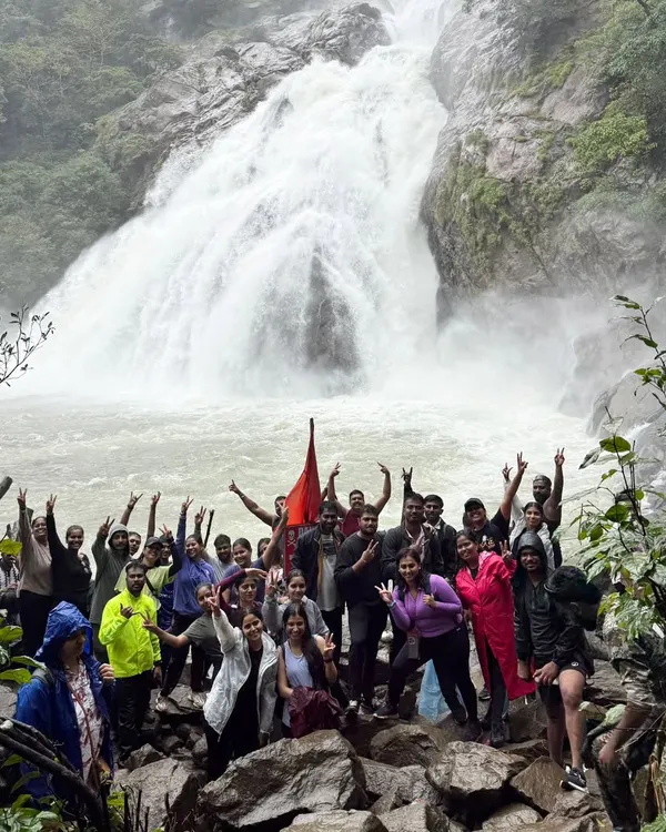 A wide-angle view of our group celebrating at the base of the mighty Dudhsagar Falls. The sheer volume of water during monsoon is a sight to behold.