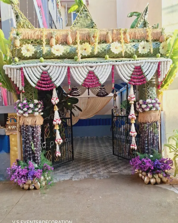 This is the kind of work that I live for. Creating a grand, traditional welcome for a home wedding using all-natural elements. The entrance is framed with pillars of sugarcane, intricate garlands of jasmine and rose petals, and a canopy woven from coconut leaves and decorated with fresh pineapples.