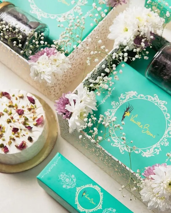 Our complete Ganesh Hamper, featuring a box of our signature Cake Mithai, assorted Cake Modaks, a jar of brownie bites, and a beautiful Rasmalai cake.