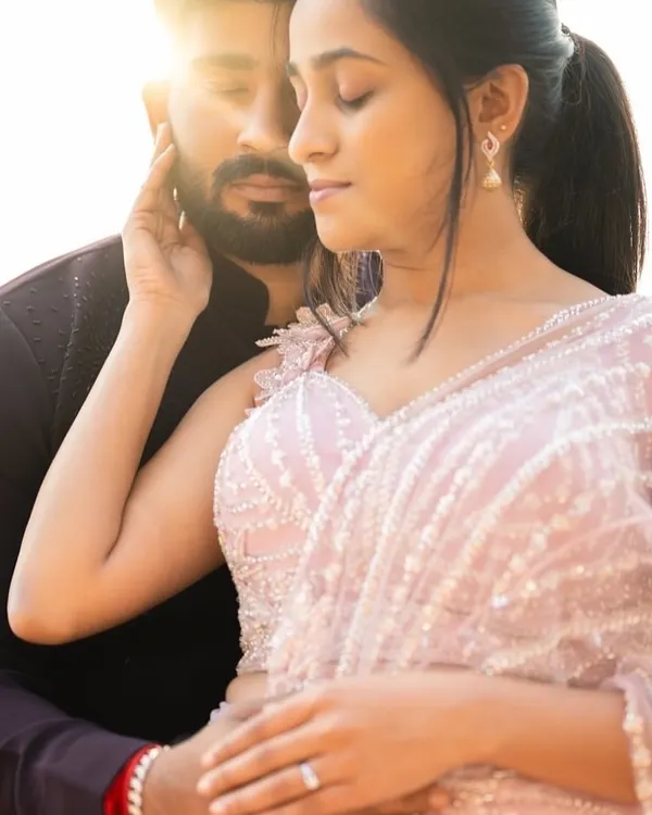 A romantic close up from a pre wedding shoot. The bride to be wears a custom lavender half saree with delicate pearl and beadwork, a soft and dreamy choice for capturing their love story.