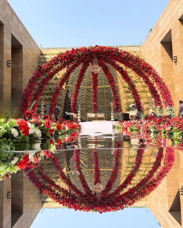 This is what I mean by a dream mandap. I designed this breathtaking dome of crimson roses, perfectly reflected to create a circle of love, turning a simple vow exchange into a moment of pure, regal grandeur.