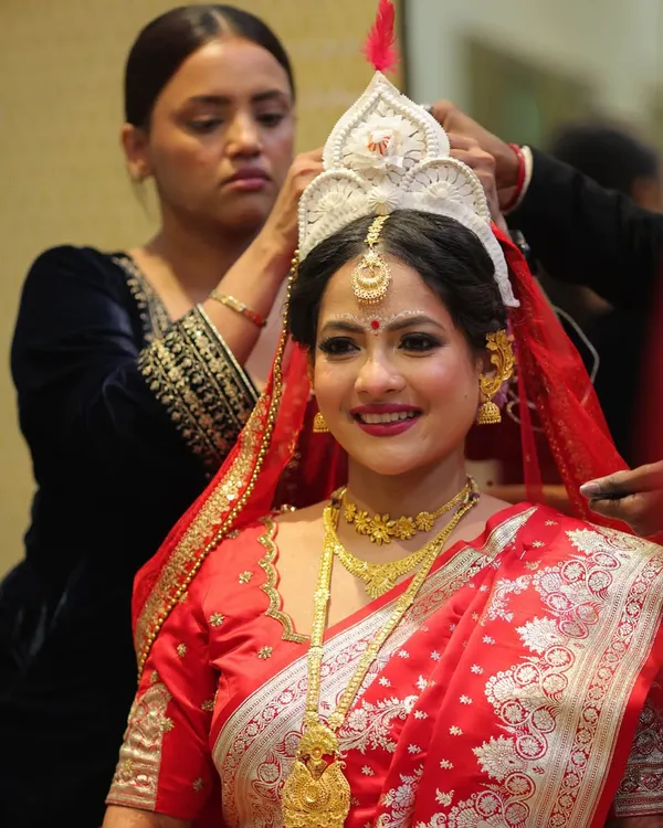 A behind-the-scenes moment of placing the traditional mukut on my beautiful Bengali bride, Anamika. It's these final touches that complete the iconic look.