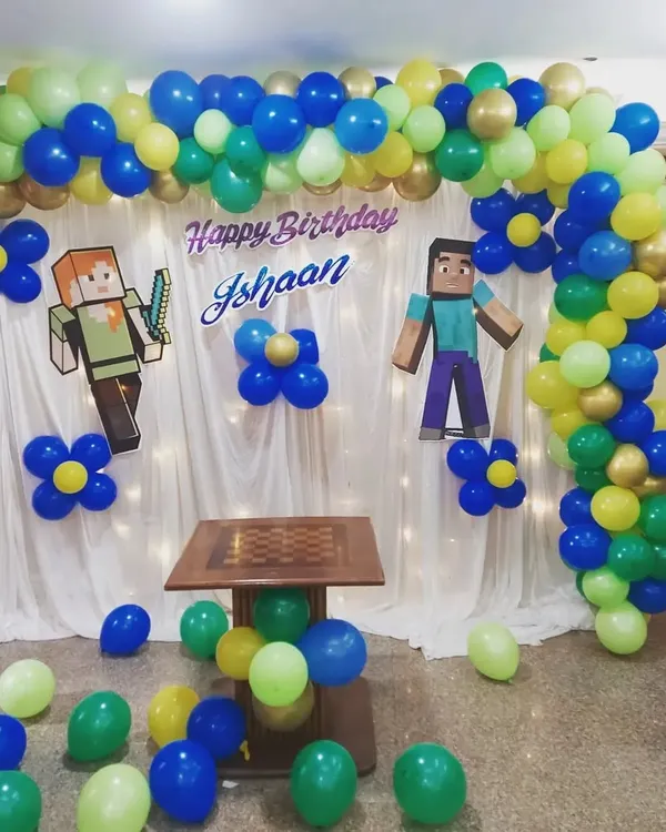A fantastic Minecraft-themed birthday backdrop. I used a combination of a balloon arch in the game's signature colors and character cutouts to create an immersive world for the birthday boy and his friends.