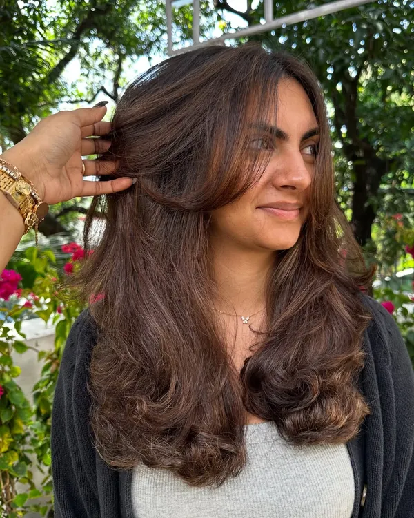 This is my signature layered cut. Notice how the face-framing pieces soften her features. The layers are designed to create movement and are easy to style at home.