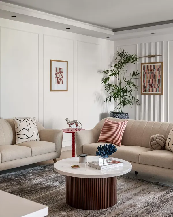 The living room in Project Dolce is a study in modern comfort. I used a neutral color palette with pops of red and blue, and mixed textures like the fluted coffee table base and soft upholstery to create a space that is both stylish and inviting.