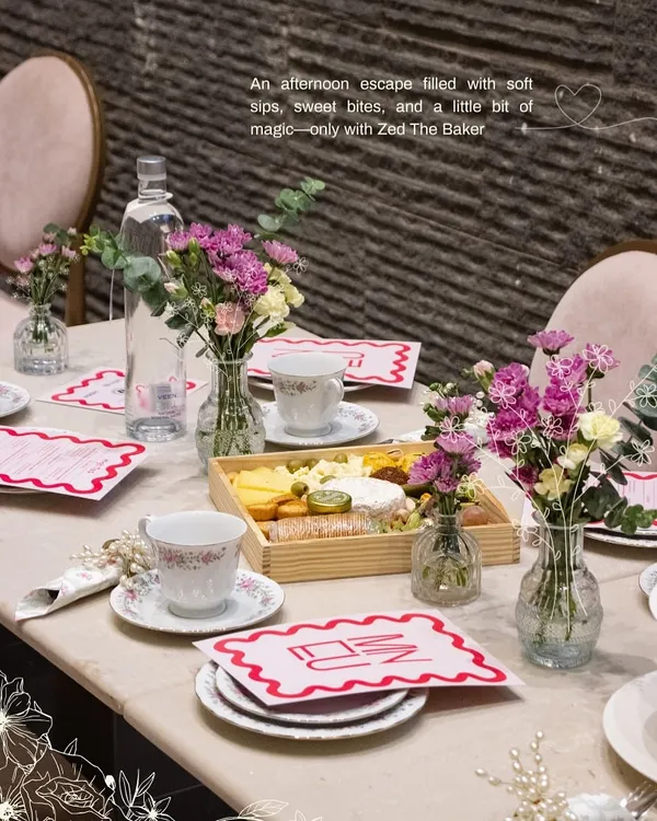 An afternoon escape is complete with a beautifully set table. For this high tea, I arranged a spread featuring a wooden cheese and fruit platter, fine china, and fresh floral bouquets to create a warm and inviting atmosphere for a private gathering.