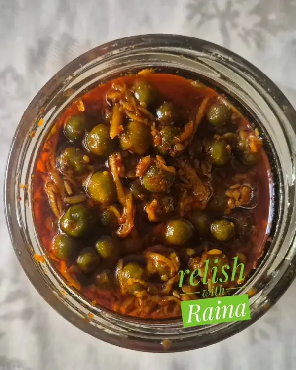 This is a jar of my authentic Rajasthani Kair Pickle. Kair are desert berries that I source directly from Rajasthan during the summer. They are soaked in buttermilk to soften and develop a sour taste before being pickled with grated raw mango and spices. It's a rare flavour that brings the taste of Rajasthan to your plate.