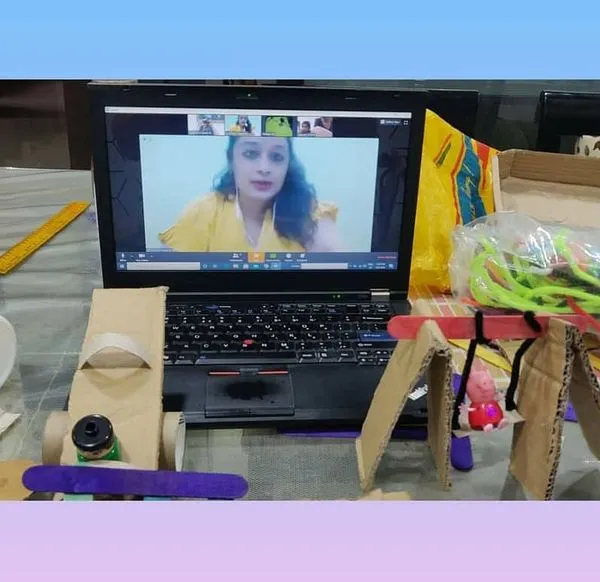 A snapshot of our online STEM class where we built a miniature playground. You can see the final creations, including a see-saw, slide, and swing, all made from simple cardboard and craft supplies.