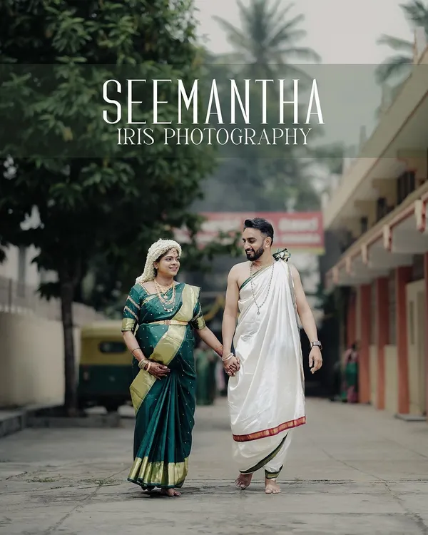 A happy couple dressed in traditional attire for their Seemantha ceremony, walking hand-in-hand down a street. This candid shot captures the joy and connection between them during this special celebration.