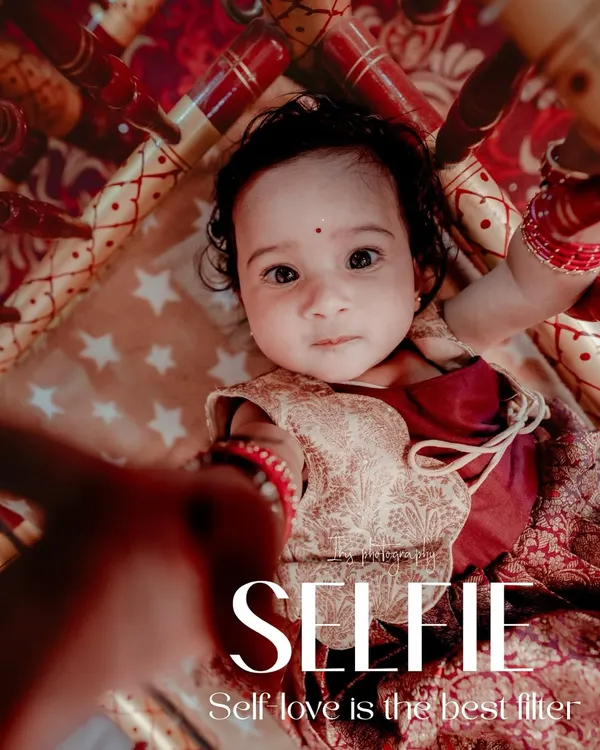 A creative and cute shot of a baby in a traditional cradle during her naming ceremony. The unique angle and "Selfie" text overlay add a modern, playful touch to this traditional event photo.